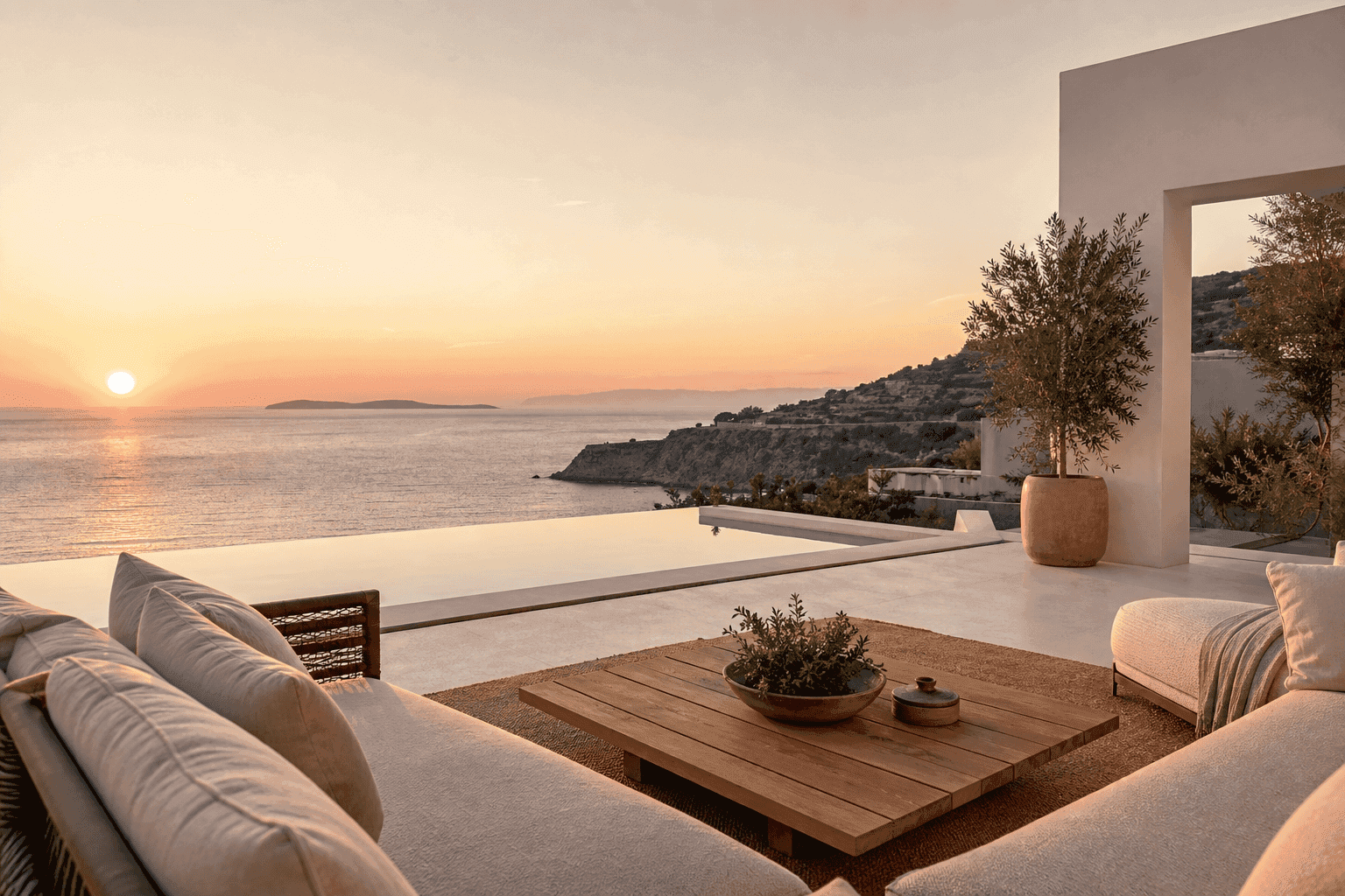 Luxury terrace with infinity pool overlooking the ocean at sunset